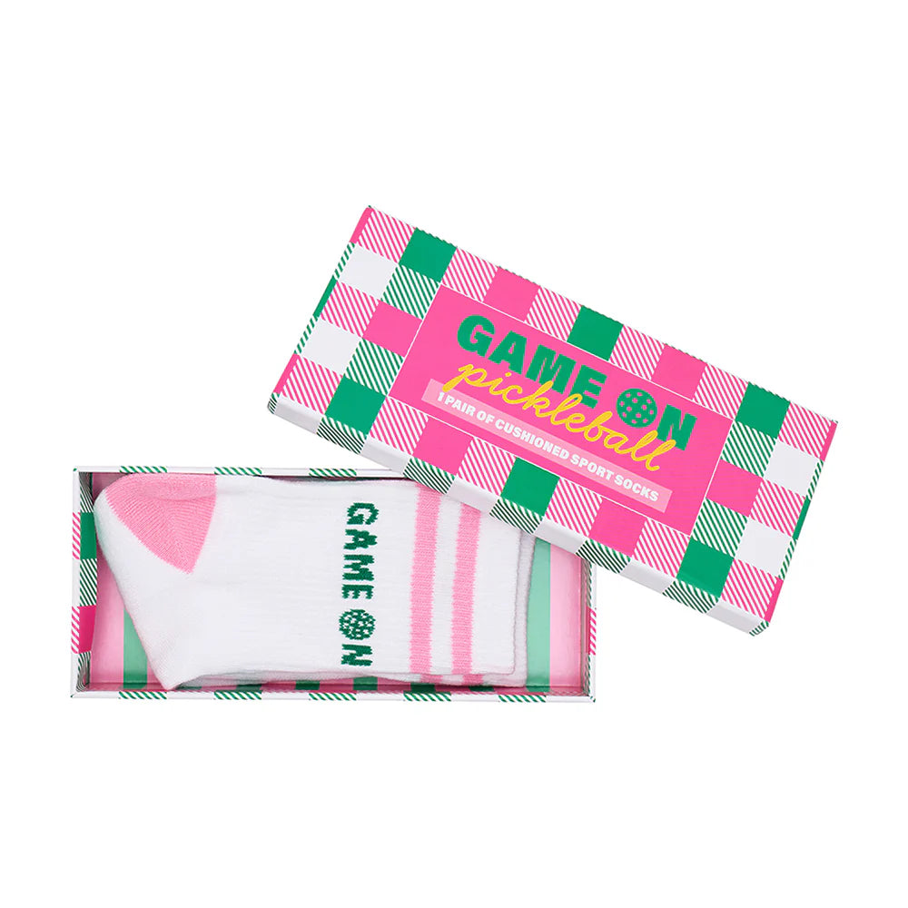 Pink and green checkered pickleball paddle packaging with 'Game On' branding with crew length socks inside.