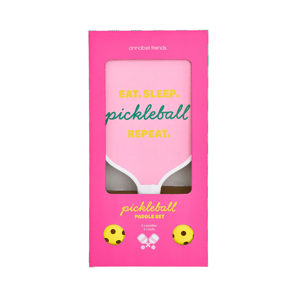 Pink pickleball paddle set packaging with text 'Eat. Sleep. Pickleball. Repeat.'