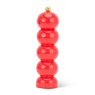 Coral-colored pepper grinder with a gold top on a white background