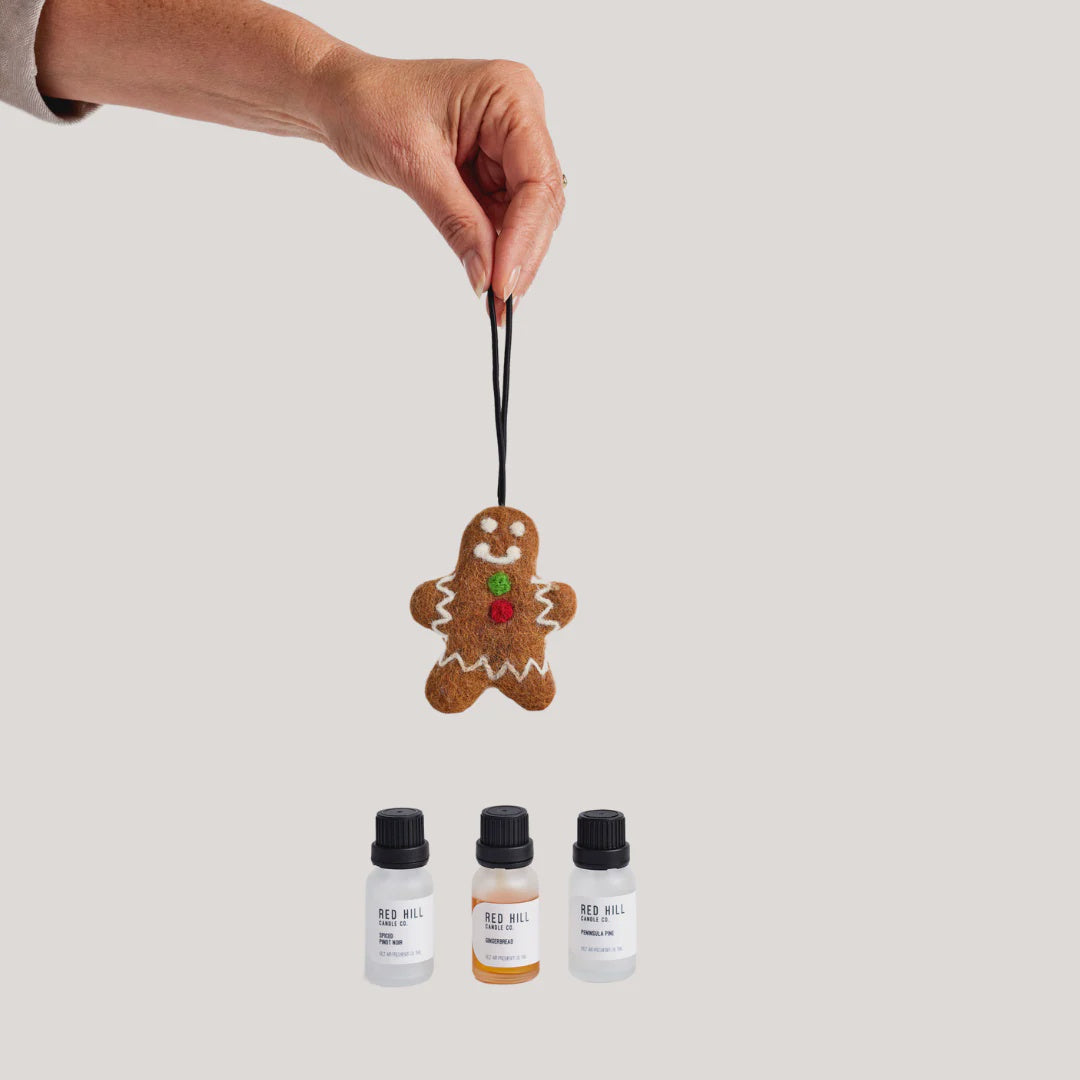 a gingerbread man-shaped hanging felt ornament for your car or wardrobe, with three scent options