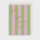 Greeting card with 'Home Sweet (New Home)!' text on a striped pink and green background