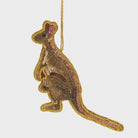 A sequin decoration in the shape of a kangaroo with gold and pink sequins on a white background.